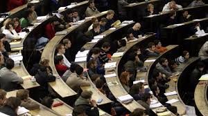Technology-for-Education-300x168 Students in a large lecture hall taking notes and listening attentively.