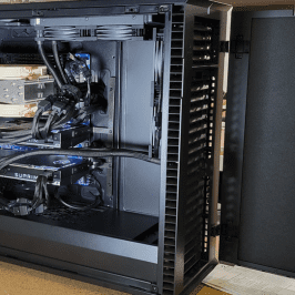 Open computer case with visible components inside.