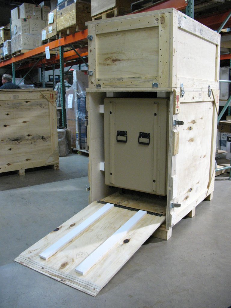 Wooden crate with ramp in warehouse. Wooden crate with ramp in warehouse.