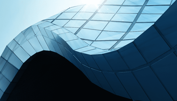 Curved glass building with sunlight reflection. Curved glass building with sunlight reflection.