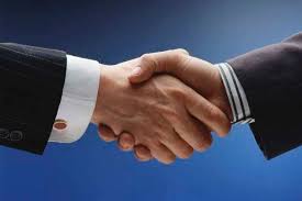 Business handshake against a blue background. Business handshake against a blue background.