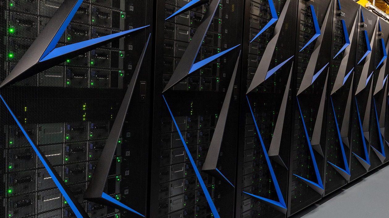 Close-up of server racks with blue cable management in a data center.
