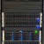 Server rack with illuminated panels and cables.