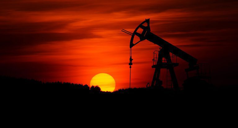Oil pumpjack silhouette against a red sunset. Oil pumpjack silhouette against a red sunset.