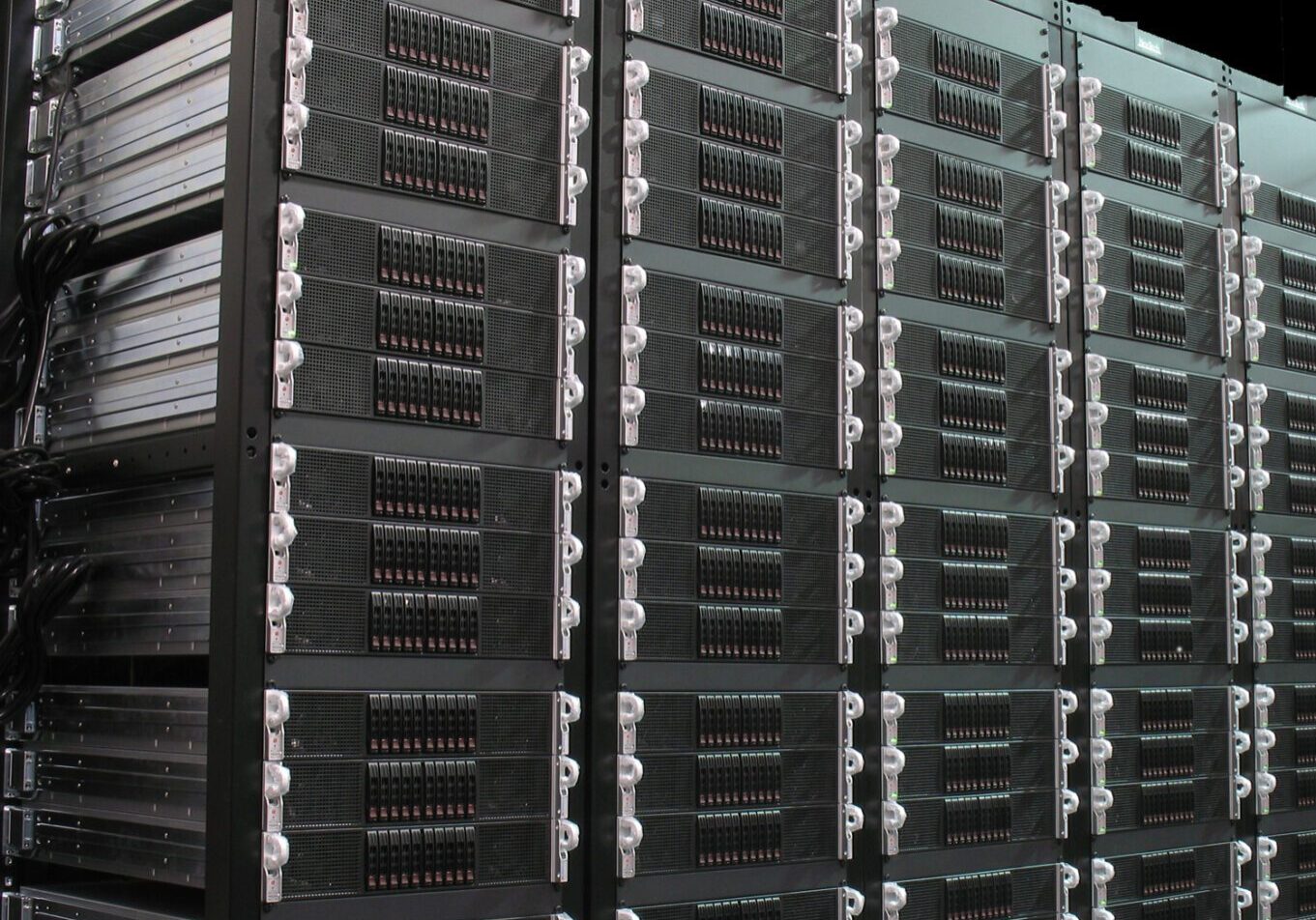 Rows of black server racks in a data center.