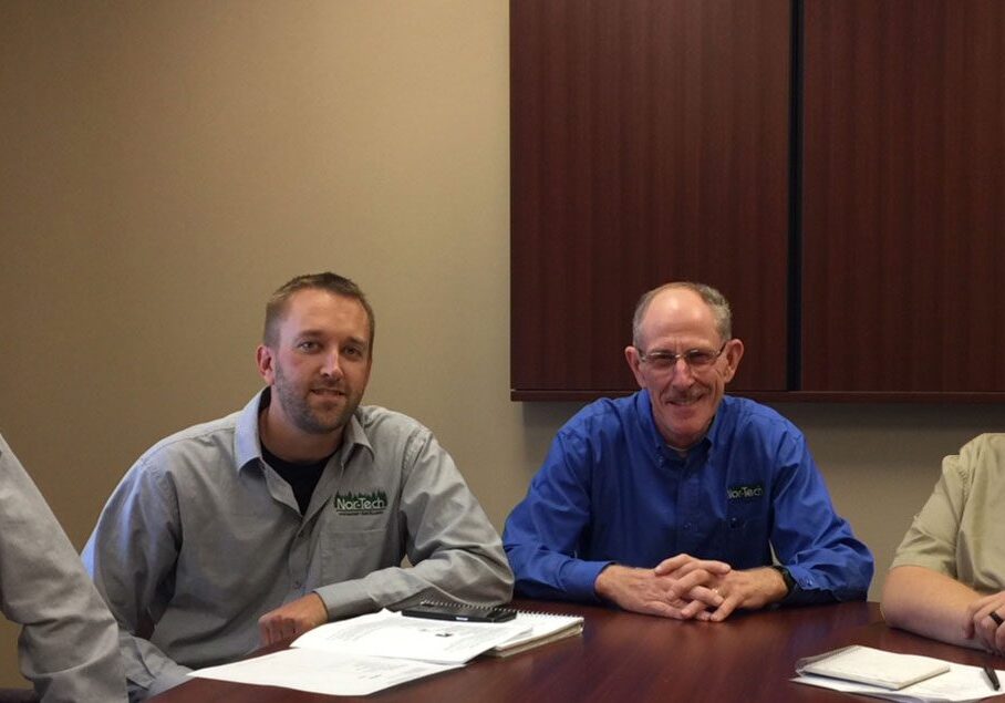 Four men sitting at a conference table.