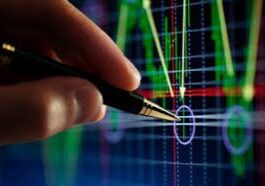 Hand analyzing financial chart with pen.