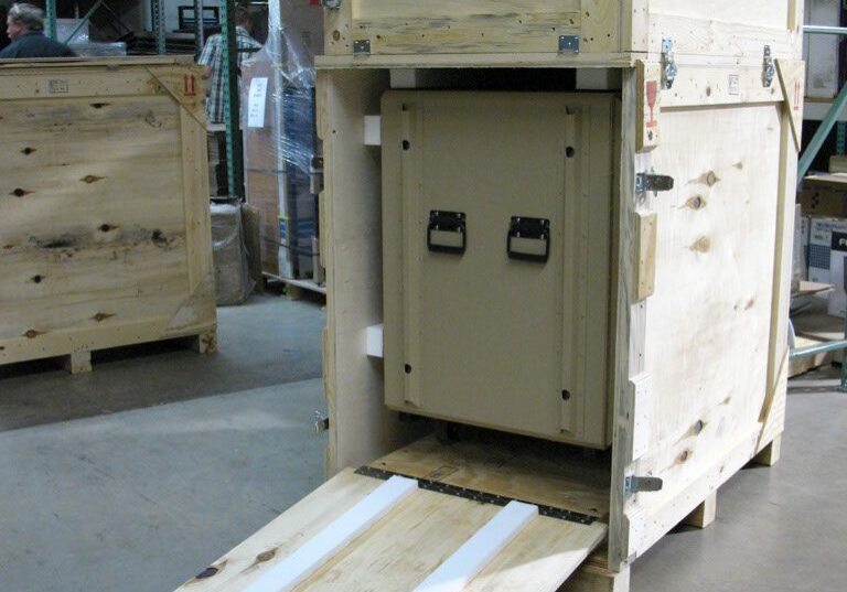 Wooden crate with ramp in warehouse.
