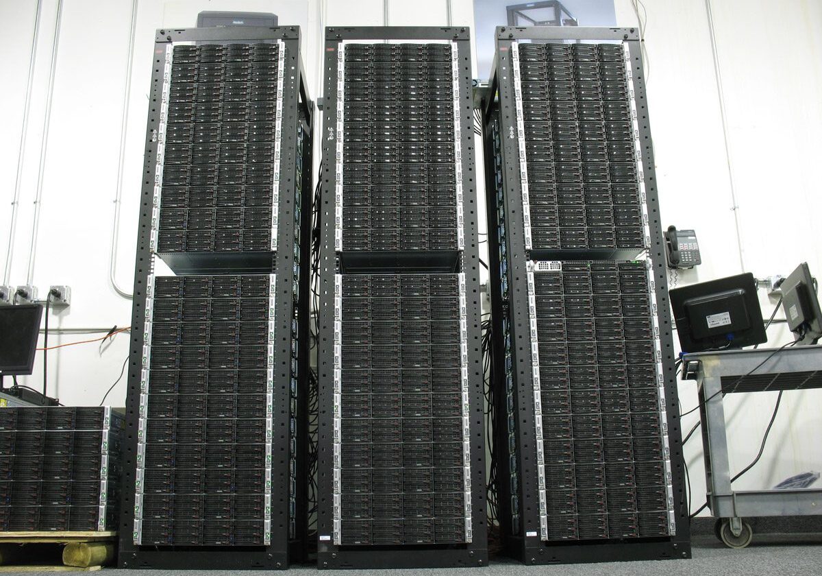 Three large server racks in data center.